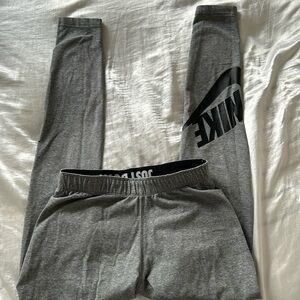 Nike gray leggings with just do it band and Nike swoosh logo on ankle